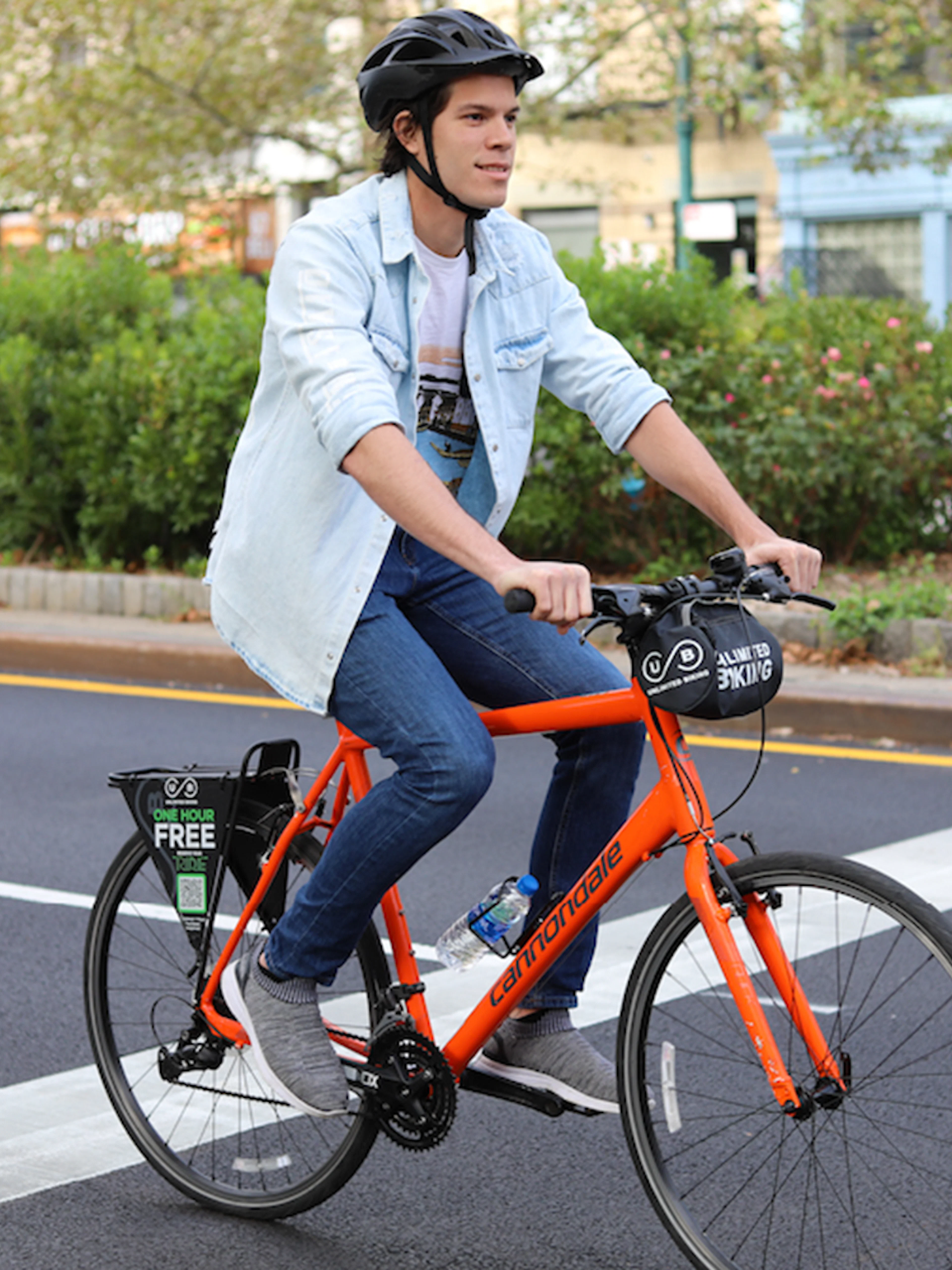 Cyclist on orange bike in Central Park, New York City.