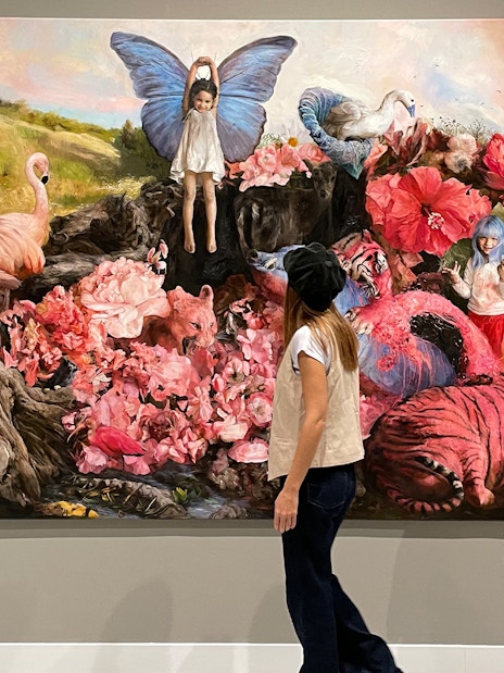 Visitor observing surreal artwork at Moco Museum Barcelona exhibit.