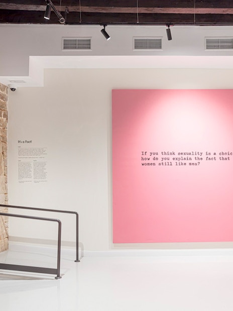 Moco Museum Barcelona interior with pink artwork featuring text.
