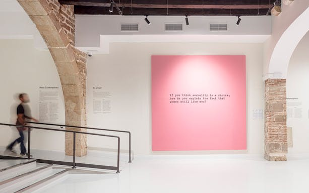 Moco Museum Barcelona interior with pink artwork featuring text.