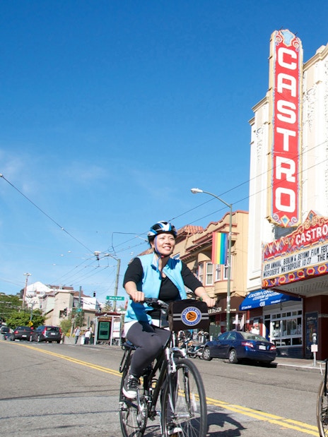 Cyclists on electric bikes in front of Castro Theatre, San Francisco.