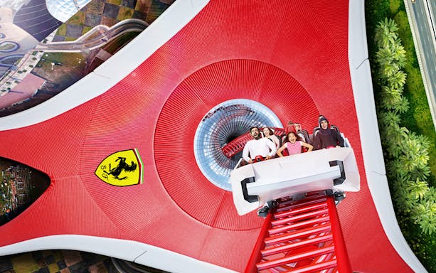 Roller coaster at Ferrari World Abu Dhabi with excited riders.