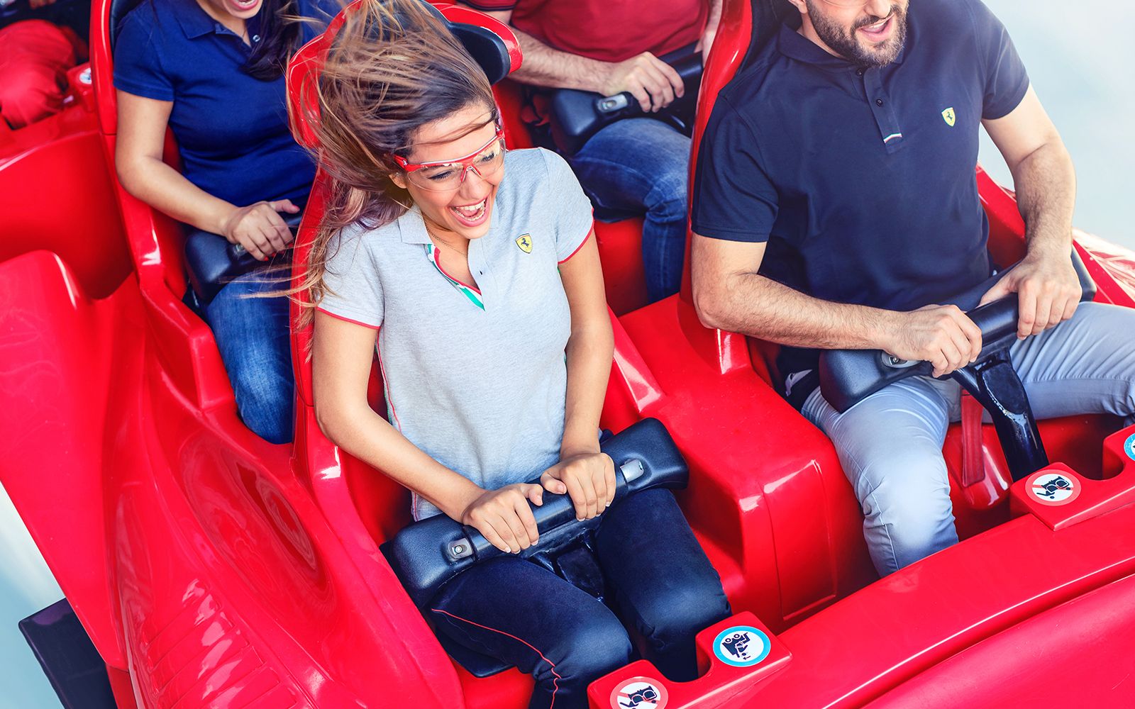 Visitors enjoying a roller coaster ride at Ferrari World Abu Dhabi.