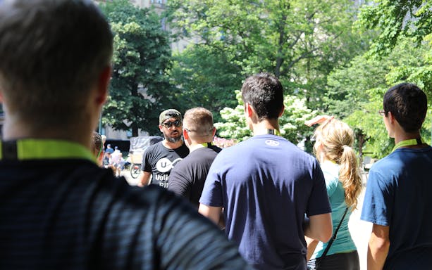 Tour guide leading a group on a Central Park walking tour.