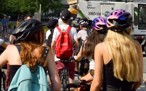 Cyclists on a New York Highlights Bike Tour with helmets and backpacks.