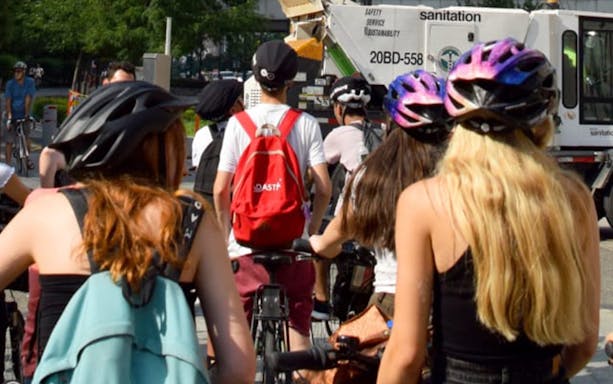 Cyclists on a New York Highlights Bike Tour with helmets and backpacks.
