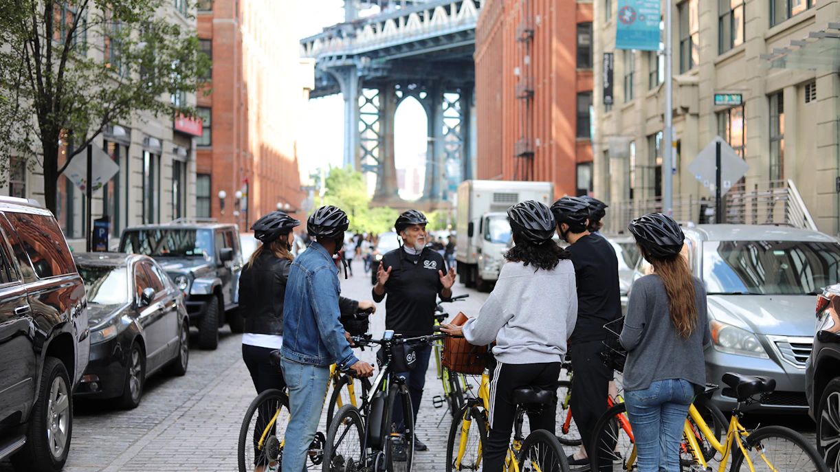 Cyclists gather near Brooklyn Bridge during a guided bike tour in New York City.