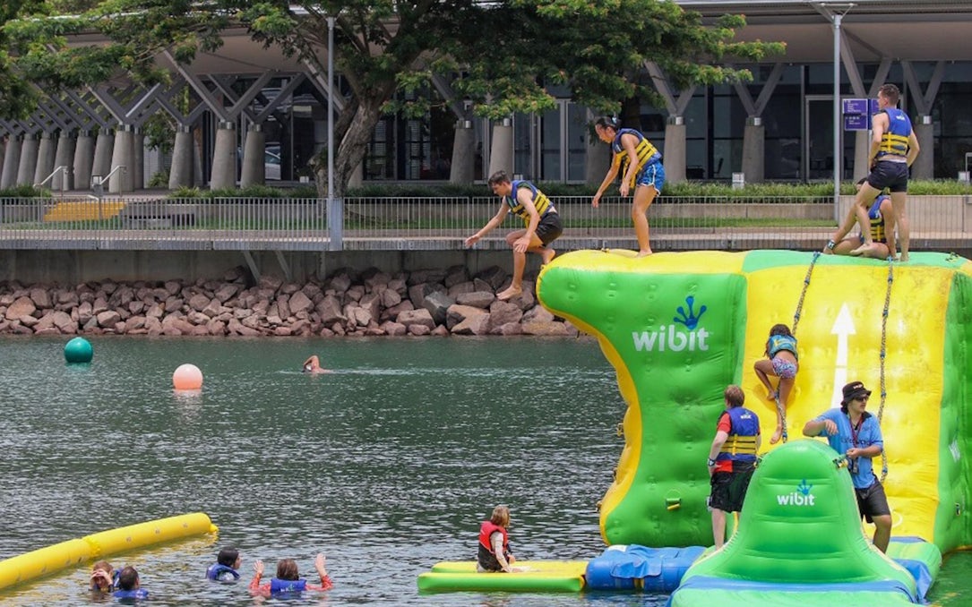 Visitors enjoying inflatable aqua park at Darwin Waterfront Recreation Lagoon.