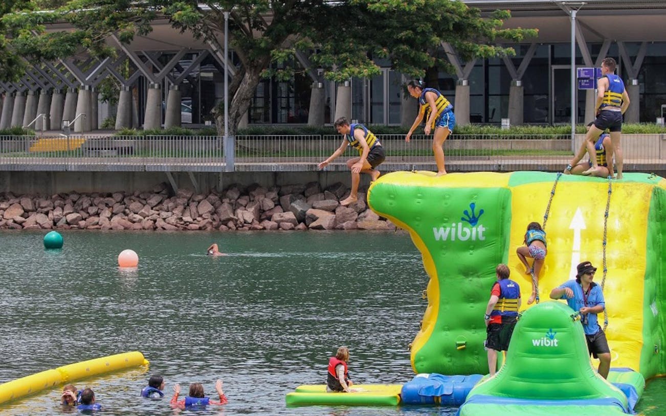 Visitors enjoying inflatable aqua park at Darwin Waterfront Recreation Lagoon.