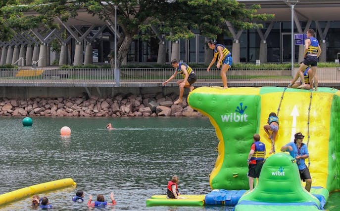 Visitors enjoying inflatable aqua park at Darwin Waterfront Recreation Lagoon.