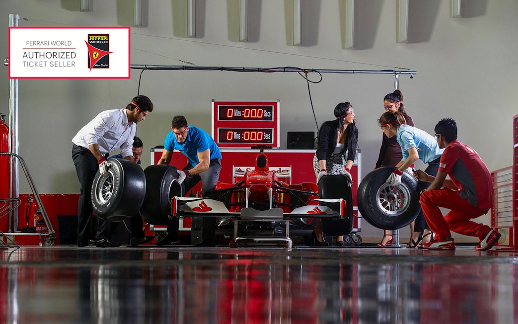 People participating in a pit stop activity at Ferrari World Abu Dhabi.