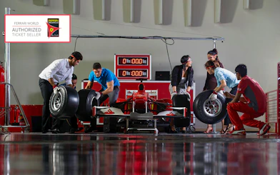 People participating in a pit stop activity at Ferrari World Abu Dhabi.