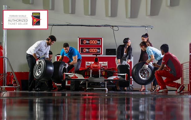 People participating in a pit stop activity at Ferrari World Abu Dhabi.