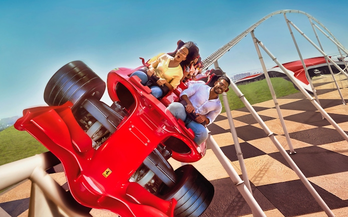 Roller coaster at Ferrari World Abu Dhabi with excited riders.