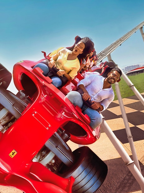 Roller coaster at Ferrari World Abu Dhabi with excited riders.