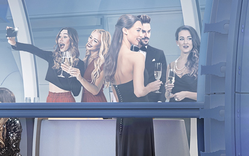 Group enjoying drinks in Ain Dubai Premium Cabin.