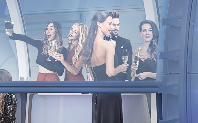 Group enjoying drinks in Ain Dubai Premium Cabin.