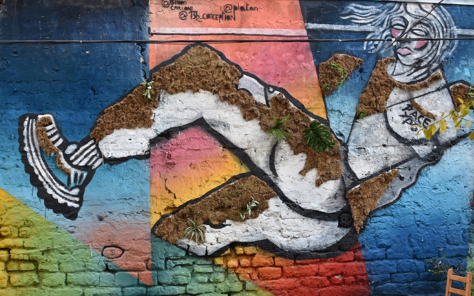 Street art mural featuring a dynamic figure with colorful geometric background.