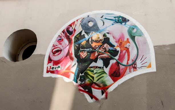 Montmartre street art featuring a colorful mural with dynamic figures and abstract elements.