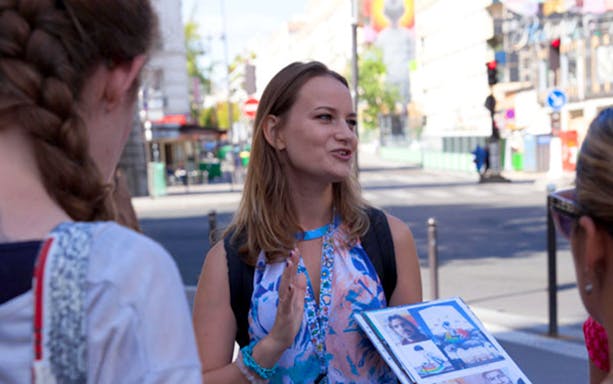 Tour guide explaining murals during the XXL Street Art Tour.