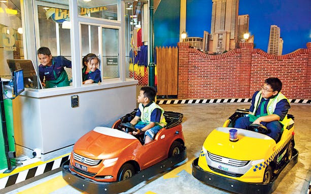 Children driving mini cars at KidZania Kuala Lumpur.