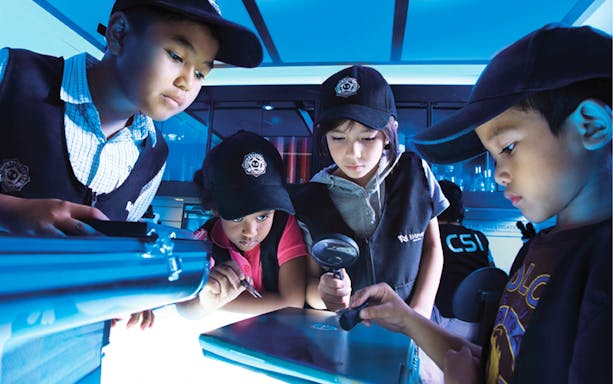 Children engaging in a detective activity at KidZania Kuala Lumpur.