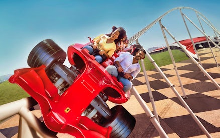 Roller coaster at Ferrari World Abu Dhabi with excited riders.
