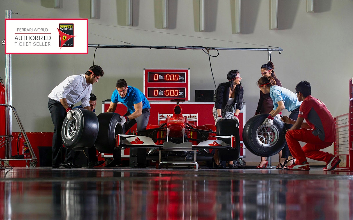 Ferrari World pit crew experience with participants changing tires, Abu Dhabi.