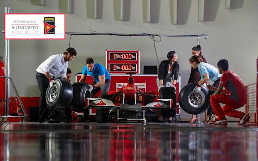 Ferrari World Abu Dhabi pit stop experience with visitors changing car tires.