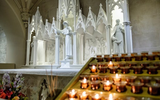 Statues and lit candles inside St Patrick's Cathedral, New York City.
