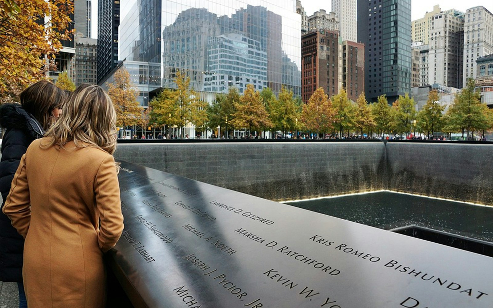 911 Memorial Museum exterior with visitors, New York City, featuring Lady Liberty Cruise.