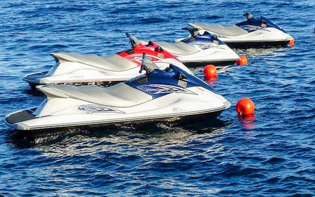 Jet skis lined up on Biscayne Bay for a 60-minute rental in Miami.