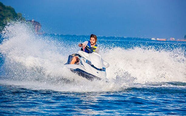 Jet skiing in Biscayne Bay, Miami with waves splashing.