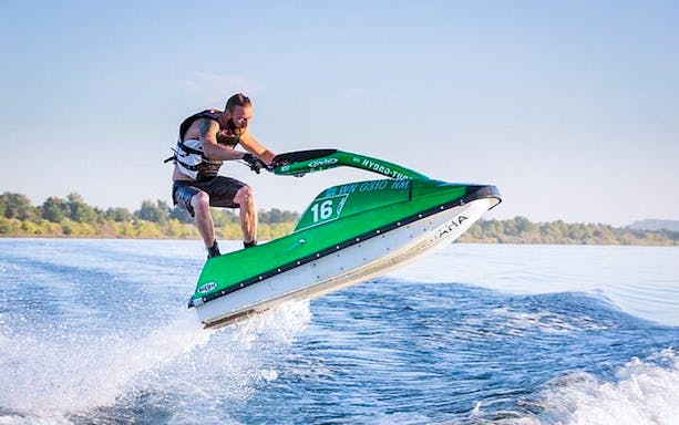 Jet skiing in Biscayne Bay, Miami, with a person riding over waves.