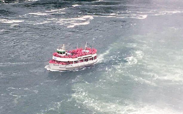 Maid of the Mist boat with tourists near Niagara Falls, USA.