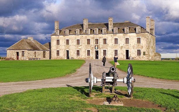 Old Fort Niagara with historic cannon on display, part of Niagara Falls USA sightseeing tour.