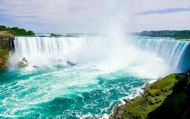 Niagara Falls USA with cascading water and mist, part of sightseeing tour.