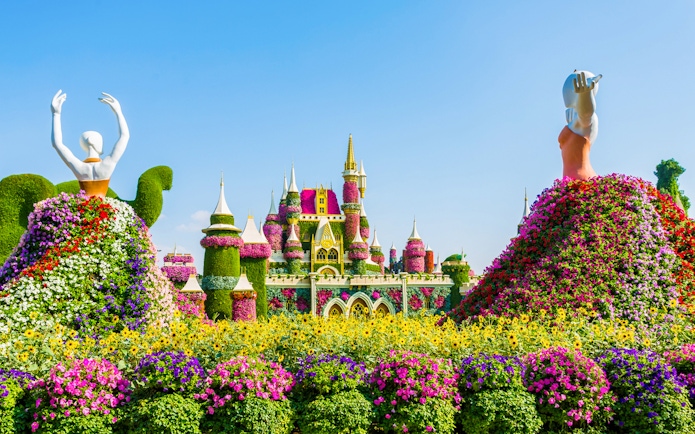 Colorful floral sculptures and castle at Dubai Miracle Garden.