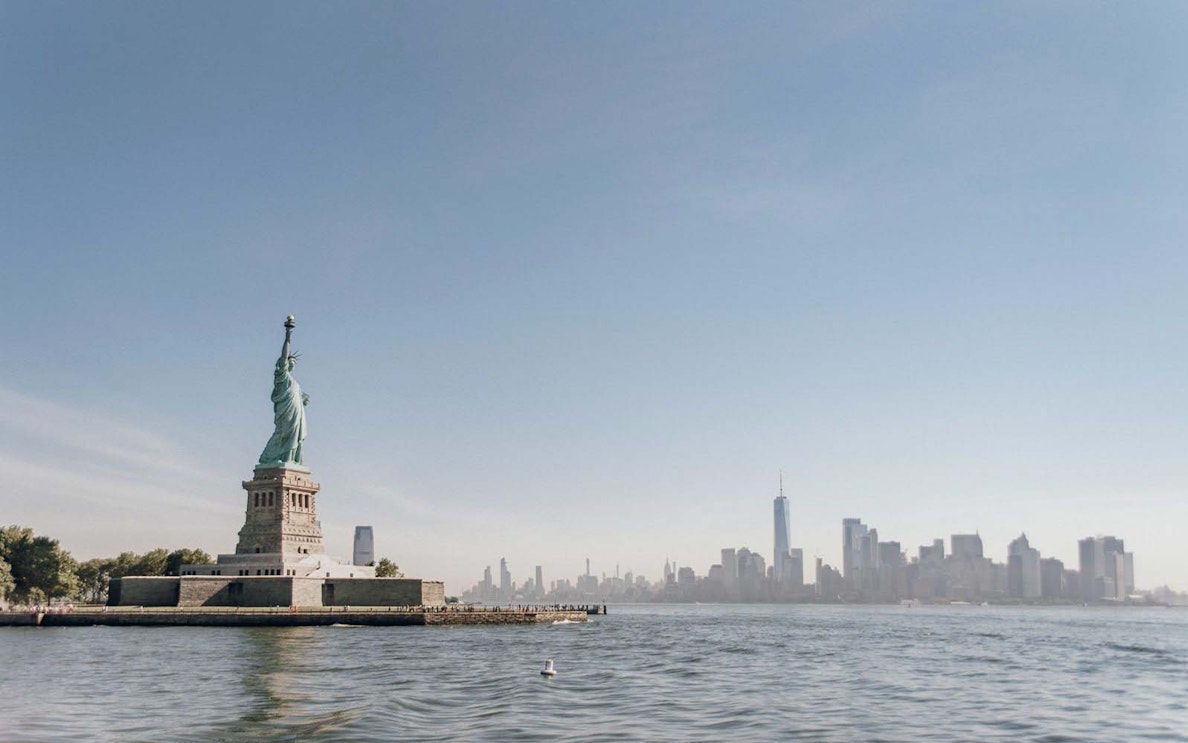 Statue of Liberty with New York City skyline in the background.