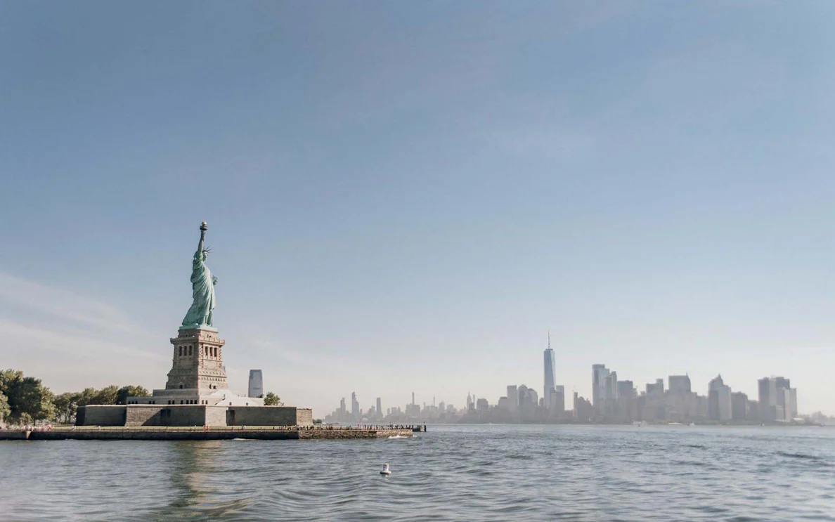Statue of Liberty with New York City skyline in the background.