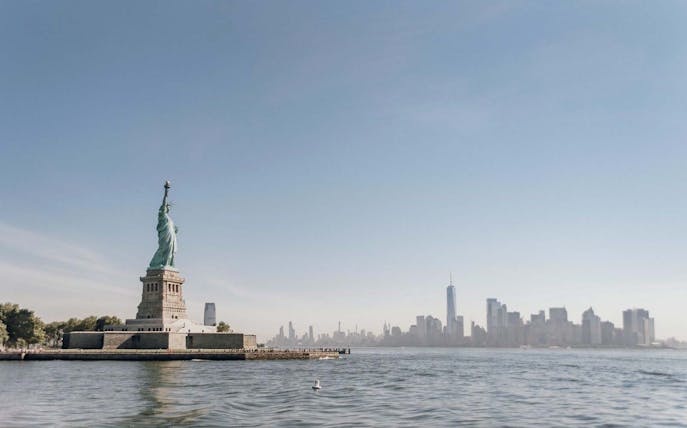 Statue of Liberty with New York City skyline in the background.
