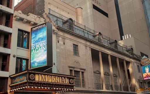 Imperial Theatre marquee in New York City, featuring a Broadway show advertisement.