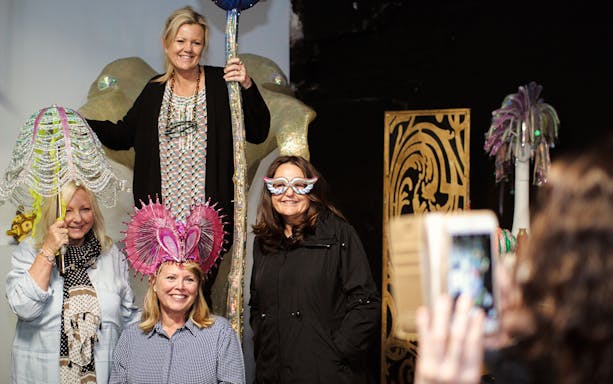 Guests enjoying costume props on the Exclusive Disney on Broadway Tour at New Amsterdam Theatre.