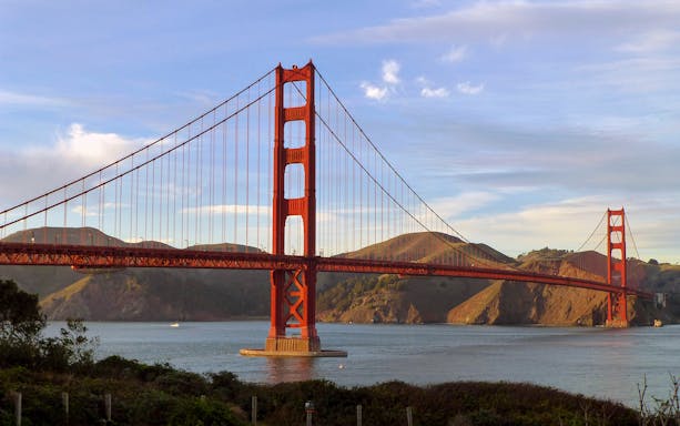 Golden Gate Bridge in San Francisco with hills in the background.