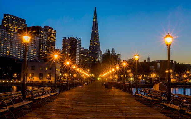 San Francisco skyline from a pier at dusk, featuring the Transamerica Pyramid.