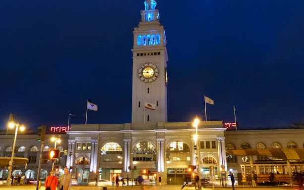 Ferry Building clock tower illuminated at night, San Francisco Bay Cruise & Double Decker Night Tour.