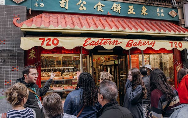 Tour group outside Eastern Bakery in Chinatown during Through The Dragon Gate tour.