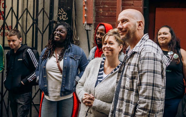 Tour group exploring Chinatown's Dragon Gate area.