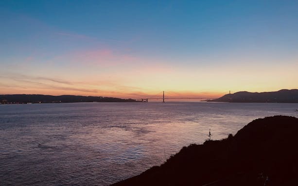 Sunset view of Golden Gate Bridge from Alcatraz Island, San Francisco.