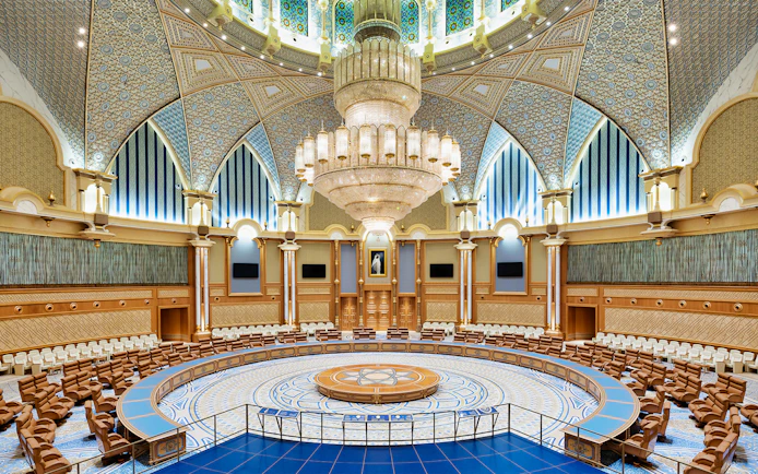 Interior of Qasr Al Watan's grand hall with ornate ceiling and large chandelier, Abu Dhabi.